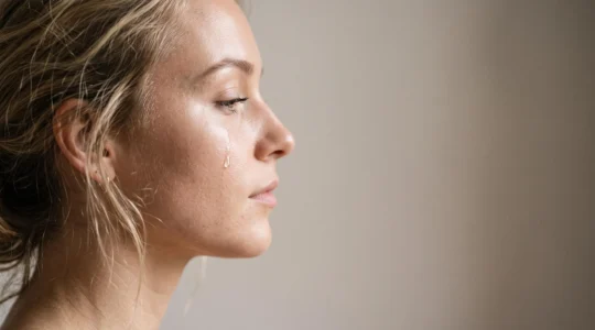 Perfil de un rostro femenino con una gota de agua deslizándose sobre la piel, simbolizando la diferencia entre hidratación real y una sensación superficial